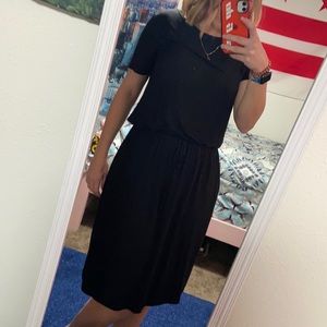 Black tee shirt dress with waist drawstring, pockets, and mini side slits